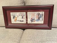 Full view of the framed dual print on sofa