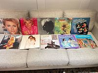 All ten LP jackets spread on sofa front view