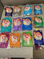 All 12 sealed Teenie Beanie Babies laid out showing numbered bags