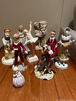 Group view of all nine porcelain figurines on tabletop