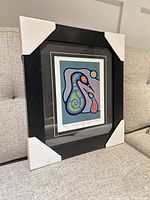 Framed print showing full artwork with corner protectors