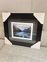 Full framed print with corner protectors on sofa