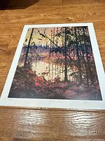 Full view of the unframed print on wooden floor