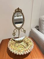 Full view of brides bowl on metal stand with mirror