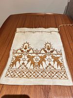 Front view showing embroidery pattern and cord