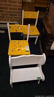 Two yellow chairs and white bench grouped