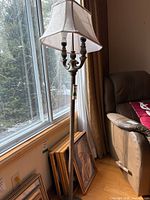 Full view of lamp by window showing shade, body, height