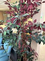 Full view of artificial tree showing mixed foliage and height