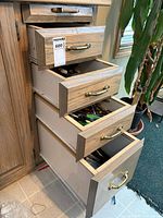 Chest of drawers open showing multiple utensil drawers