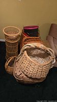 Overall assortment showing multiple wicker and wood baskets stacked together