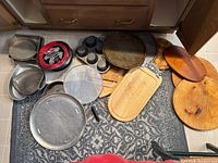 Group shot of all boards, pans and strainer spread on floor