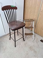 Front view of bar stool beside additional folding item