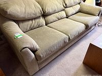 Full view of beige 3-seater sofa on carpeted floor
