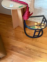 End table next to another table, showing blue frame and glass top