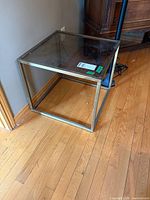Overall view of square metal and glass end table