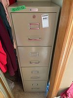 Full view of beige four-drawer filing cabinet inside closet