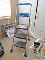 Front view of 3-step ladder showing tray and steps