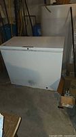 Front view of Frigidaire chest freezer showing overall size and wear