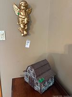 Barn and cherub displayed together