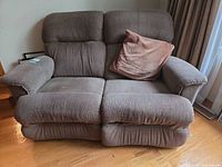 Front view of La-Z-Boy fabric loveseat recliner with pillow