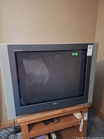 Front view of LG 32-inch CRT television on stand