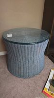 Full view of wicker side table with glass top