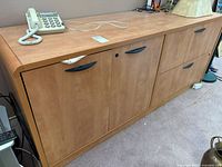 Front view of sideboard showing overall form, drawers, cabinets, handles