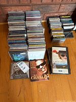 Stacks of CDs, cassette tapes and VHS laid out on floor