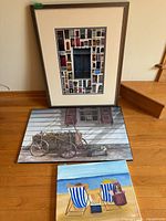 All three artworks grouped: framed collage print rear, wagon and beach canvases front