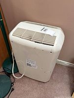 Rear and side view of dehumidifier showing power cord, grille and wear