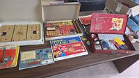 Overall lot showing Meccano parts case, Science Fair kit, Hockey CentSation board and box on table