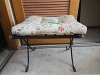 Front view showing stool frame, cushion and brass accents