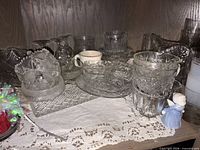 Overall view of mixed clear glassware, mug, angel figurine