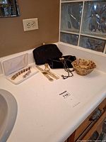 Entire lot on countertop showing jewellery case, watches, bags and bowl