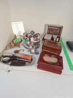 Overall lot showing jewelry boxes, figurine, adapter case, decor items