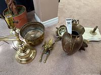 Group view of lamp base, planter bowl, copper pitcher, door knocker, marble base with brass fixture parts