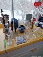 Group shot of all vases, figurines, crystal bowl, tile