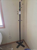 Full view of coat rack in corner showing height and overall design