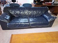 Full view of navy leather sofa front