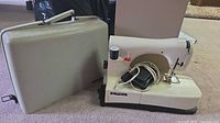 Necchi sewing machine beside hard case, cords and pedal shown