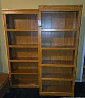 front view of both bookcases side-by-side showing shelves and overall appearance