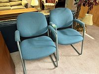 Pair of blue/teal sled-base chairs front view