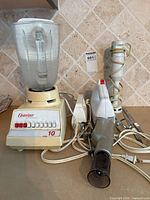 Overall view of countertop blender, immersion blender components, and glass bowl
