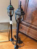 Both lantern posts standing side by side showing design and overall height