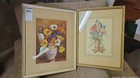 Both framed floral prints side by side on sofa