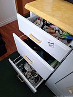 Drawer with iron and cords, shows overall item context