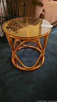 Overall view of rattan side table with glass top