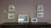 Six framed prints on display wall