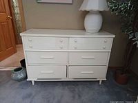Front view of dresser with lamp on top