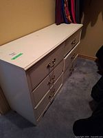 Front angled view showing six drawers and brass handles